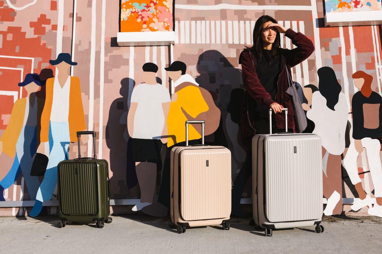 services-img Young woman with suitcases in front of a vibrant urban mural