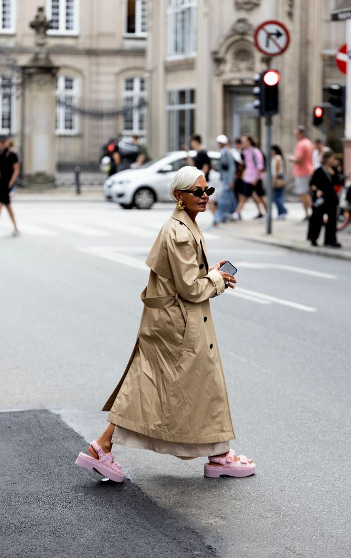 services-04 Stylish woman wearing trench coat crossing a busy city street in Copenhagen, Denmark.
